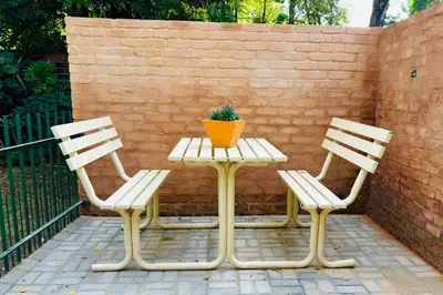 three chairs and a table with a potted plant on it at Cozy Corner in Groblersdal
