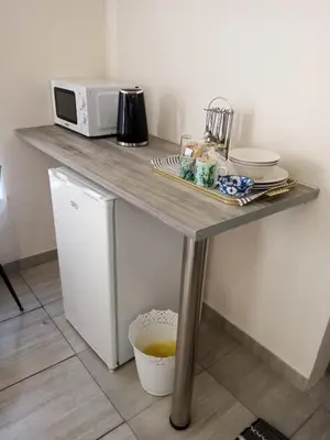 a table with a microwave on top of it at Cozy Corner in Groblersdal