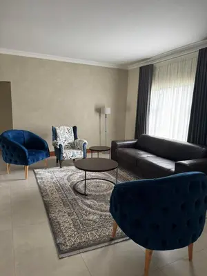 a living room with a couch and chairs and a table at The 314 Euphoria Golf Estate in Naboomspruit