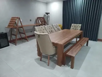 a wooden table and chairs in a room at The 314 Euphoria Golf Estate in Naboomspruit