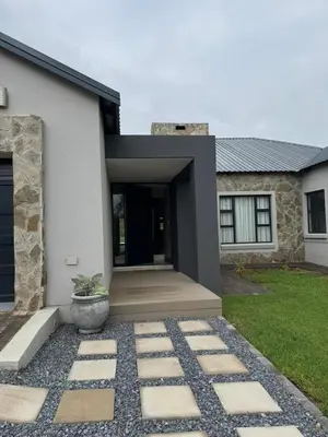 a house with a stone pathway in front of it at The 314 Euphoria Golf Estate in Naboomspruit