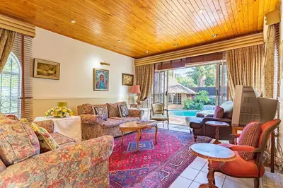 a living room with a couch and a table at Bay Tree Guest House in Pretoria