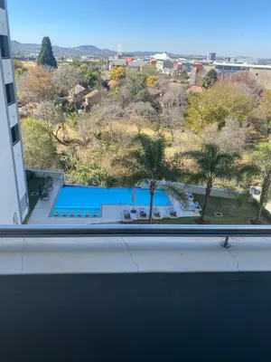 a view of a swimming pool from a window at Luxurious 2 bedroom @ The Regency Hotel in Pretoria