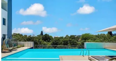 a swimming pool on the roof of a house at Luxurious 2 bedroom @ The Regency Hotel in Pretoria