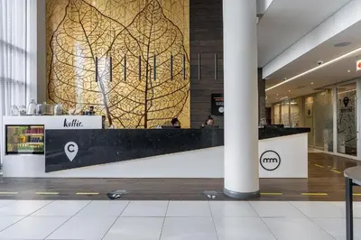 a lobby with a reception desk in a building at Menlyn Maine Trilogy Apartment 1215 in Pretoria