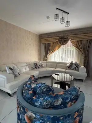 a living room with a couch and a table at Blissful stay in Polokwane
