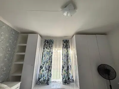 a room with a window with curtains and a fan at Blissful stay in Polokwane