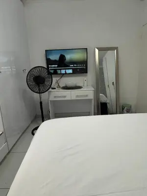 a bedroom with a bed and a flat screen tv at Blissful stay in Polokwane