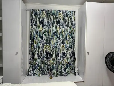 a window with a floral curtain in a bedroom at Blissful stay in Polokwane