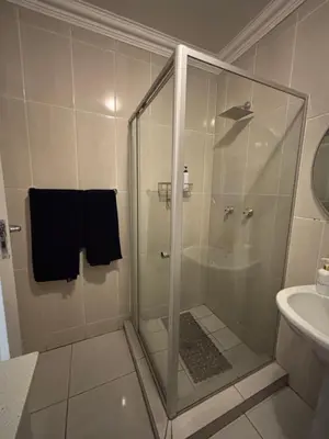 a shower with a glass door in a bathroom at Blissful stay in Polokwane