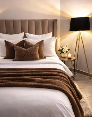 a bedroom with a large bed and a lamp at Midrand Chic Oasis in Midrand