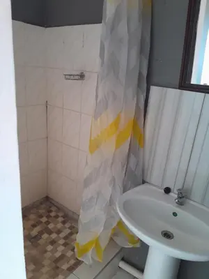 a bathroom with a sink and a shower curtain at Letz Guest Lodge in Bochum