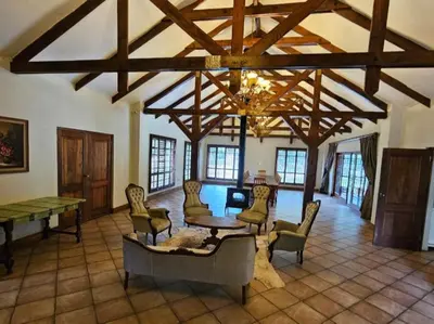 a large living room with a table and chairs at Arum Lily Eloff in Delmas