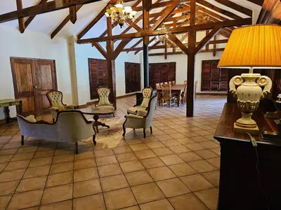 a living room with chairs and a table with a lamp at Arum Lily Eloff in Delmas
