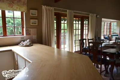 a kitchen with a counter top and a dining room at Forest Vista in Dullstroom