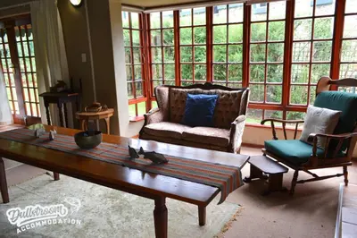 a living room with a couch and a coffee table at Forest Vista in Dullstroom