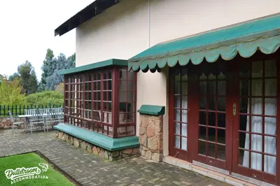 a building with a bench outside of it at Forest Vista in Dullstroom