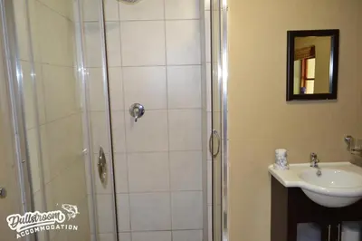 a bathroom with a shower and a sink at Forest Vista in Dullstroom