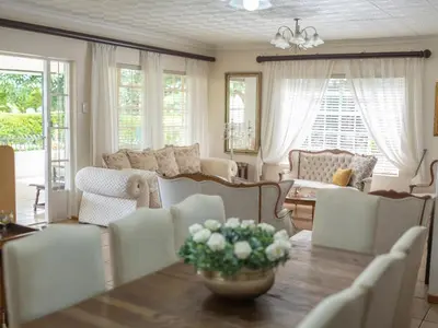 a living room with a table and chairs at Rose and Ivy Cottages in Louis Trichardt
