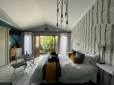 a bedroom with a large bed in a room at Dullies Dolce in Dullstroom
