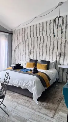 a bedroom with a large bed with a canopy at Dullies Dolce in Dullstroom