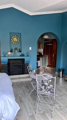 a room with a table and a blue wall at Dullies Dolce in Dullstroom