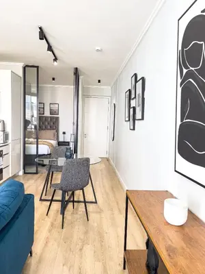 a living room with a table and a couch at ERL Ellipse Waterfall. in Midrand