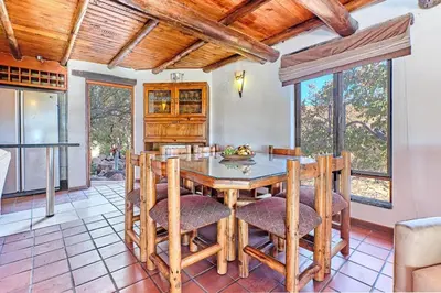 a kitchen and dining room with a table and chairs at Thula-Thula Private Game Lodge Mabalingwe in Bela-Bela