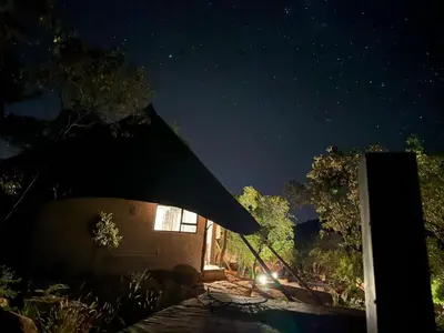 a night view of a building with a starry sky at Thula-Thula Private Game Lodge Mabalingwe in Bela-Bela