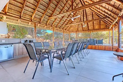 a dining room with a table and chairs at Thula-Thula Private Game Lodge Mabalingwe in Bela-Bela