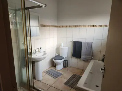 a bathroom with a toilet and a sink and a shower at View on 83 in Tzaneen