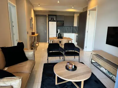 a living room with a couch and a table at Menlyn Maine Triology - 10 On Capital in Pretoria