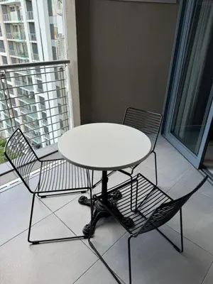 a white table and two chairs on a balcony at Menlyn Maine Triology - 10 On Capital in Pretoria