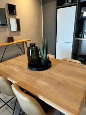 a table with a vase and a plant on it at Menlyn Maine Triology - 10 On Capital in Pretoria