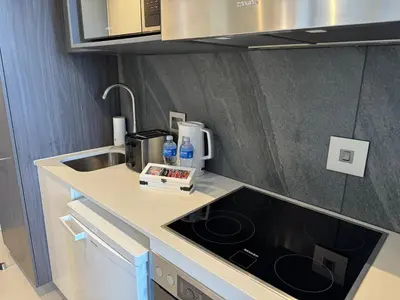 a kitchen with a sink and a stove top oven at Menlyn Maine Triology - 10 On Capital in Pretoria