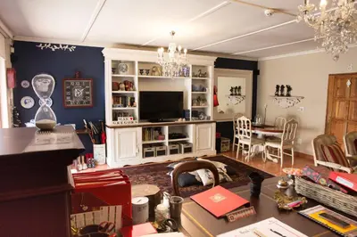 a living room with a table and a dining room at MacGregors Guest House in Pretoria