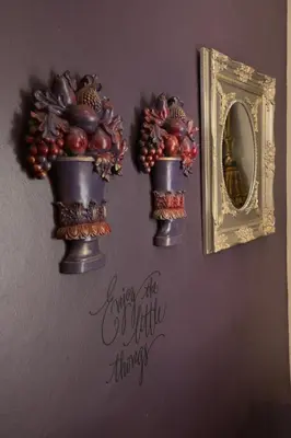 a wall with three flower pots on a wall with a mirror at MacGregors Guest House in Pretoria