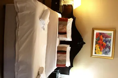 a towel rack in a room with towels at Airport Lodge Guest House in Kempton Park