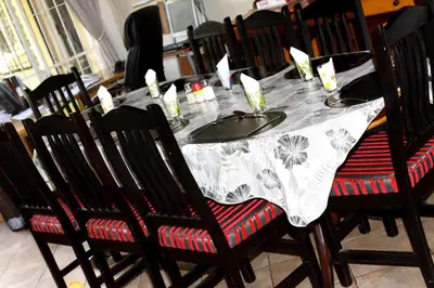 a dining room table with a white and black table cloth at Airport Lodge Guest House in Kempton Park