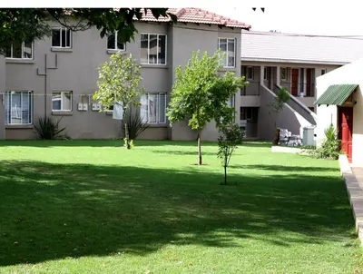 a yard in front of a building at Airport Lodge Guest House in Kempton Park