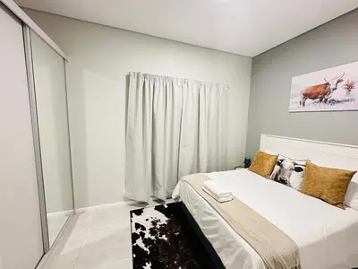 a bedroom with a bed and a window at Shamah in Pretoria
