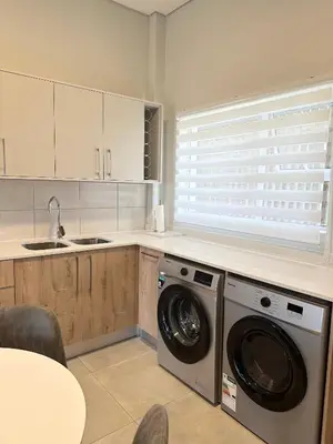 a kitchen with a washing machine and a sink at Shamah in Pretoria