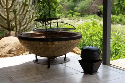 a large bird bath sitting on a patio at The Good Host in Waterval-Onder