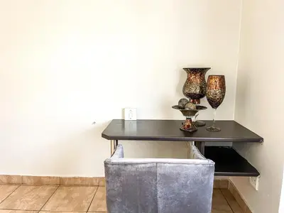 a table with vases and wine glasses on it at Bobisemo Luxury Guesthouse in Pretoria