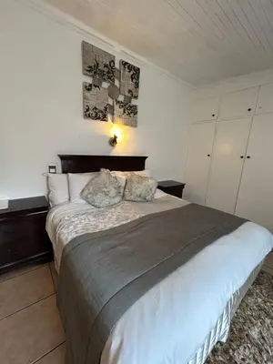 a bedroom with a large bed with two pillows at Lebamboo On Protea in Pretoria