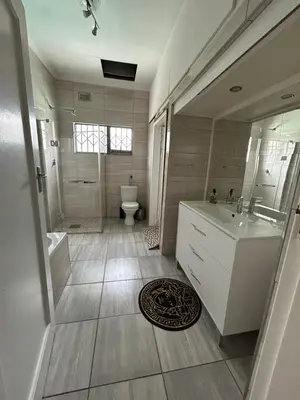a bathroom with a tub and a sink and a toilet at Lebamboo On Protea in Pretoria