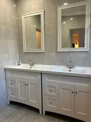 a bathroom with two sinks and two mirrors at Lebamboo On Protea in Pretoria