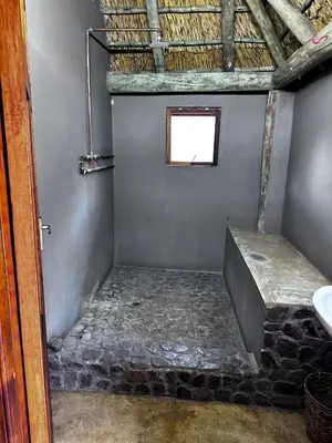 a small bathroom with a window and a sink at Rockfig Tented Camp in Assen