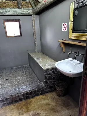a bathroom with a sink and a bath tub at Rockfig Tented Camp in Assen