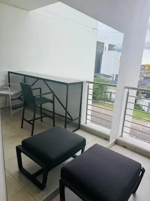 a balcony with two chairs and a table and two windows at Luxury 3 Bedroom Apartment in Carlswald in Erand